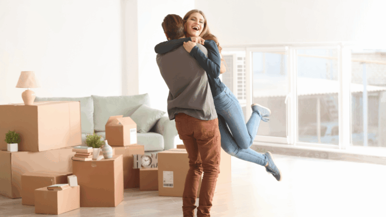 Young couple unpacking boxes in a new living room